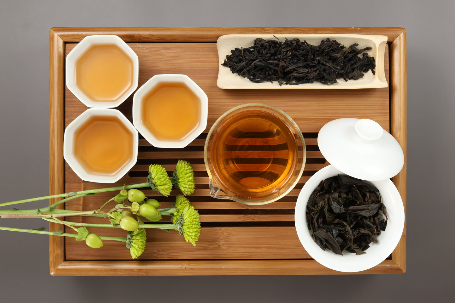 Detailed photo of Bao Zhong Oolong (Traditional Heavy Roasted) on a Bamboo Tea Tray with Dry, Wet and Brewed Bao Zhong Oolong (Traditional Heavy Roasted) from Taiwan featured prominently.