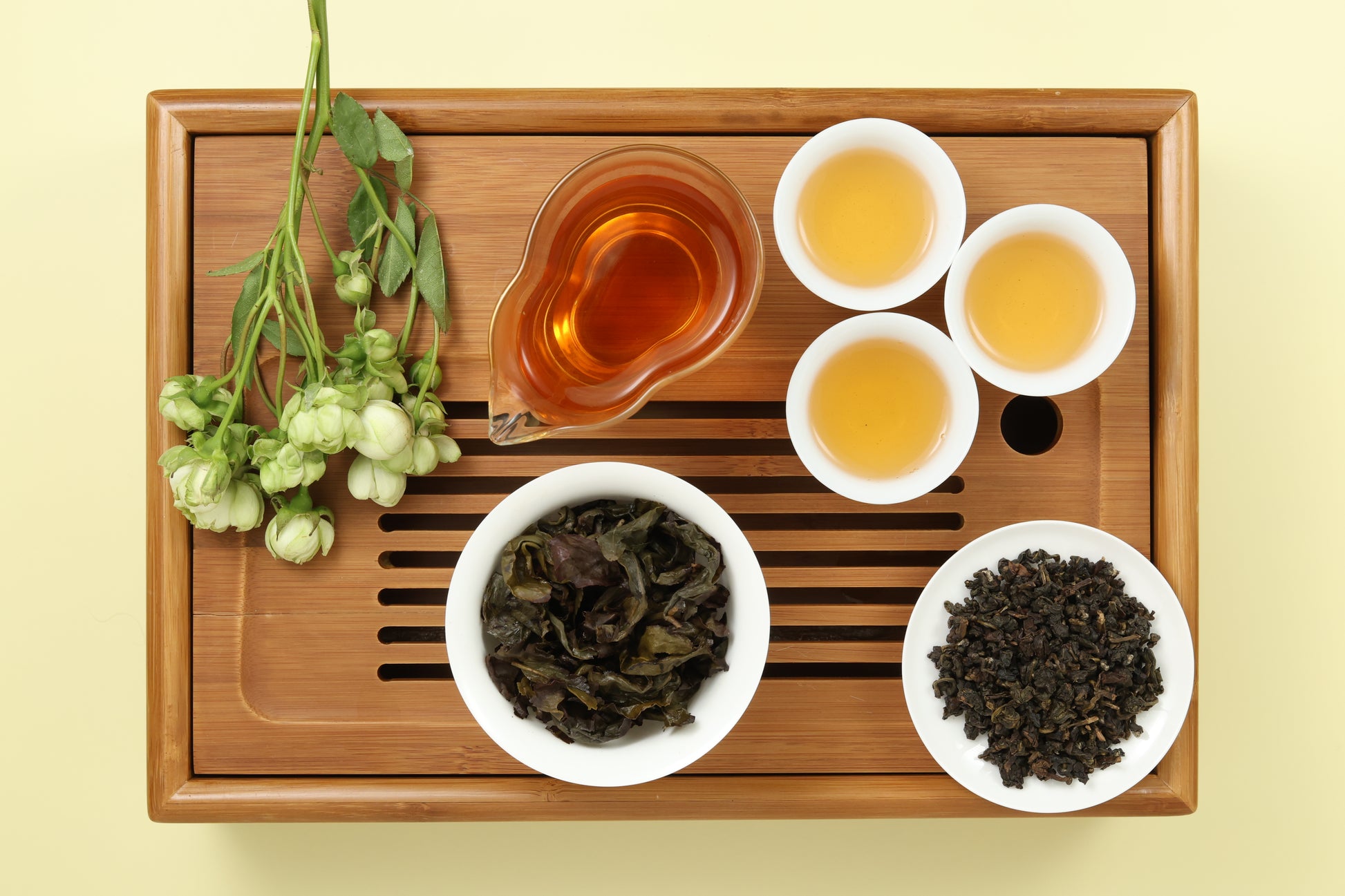 Detailed photo of Gui Fei Honey Oolong on a Bamboo Tea Tray with Dry, Wet and Brewed Gui Fei Honey Oolong from Taiwan featured prominently.