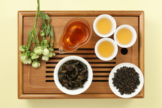 Detailed photo of Gui Fei Honey Oolong on a Bamboo Tea Tray with Dry, Wet and Brewed Gui Fei Honey Oolong from Taiwan featured prominently.
