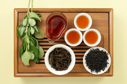 Detailed photo of Honey Black Tea on a Bamboo Tea Tray with Dry, Wet and Brewed Honey Black Tea from Taiwan featured prominently.