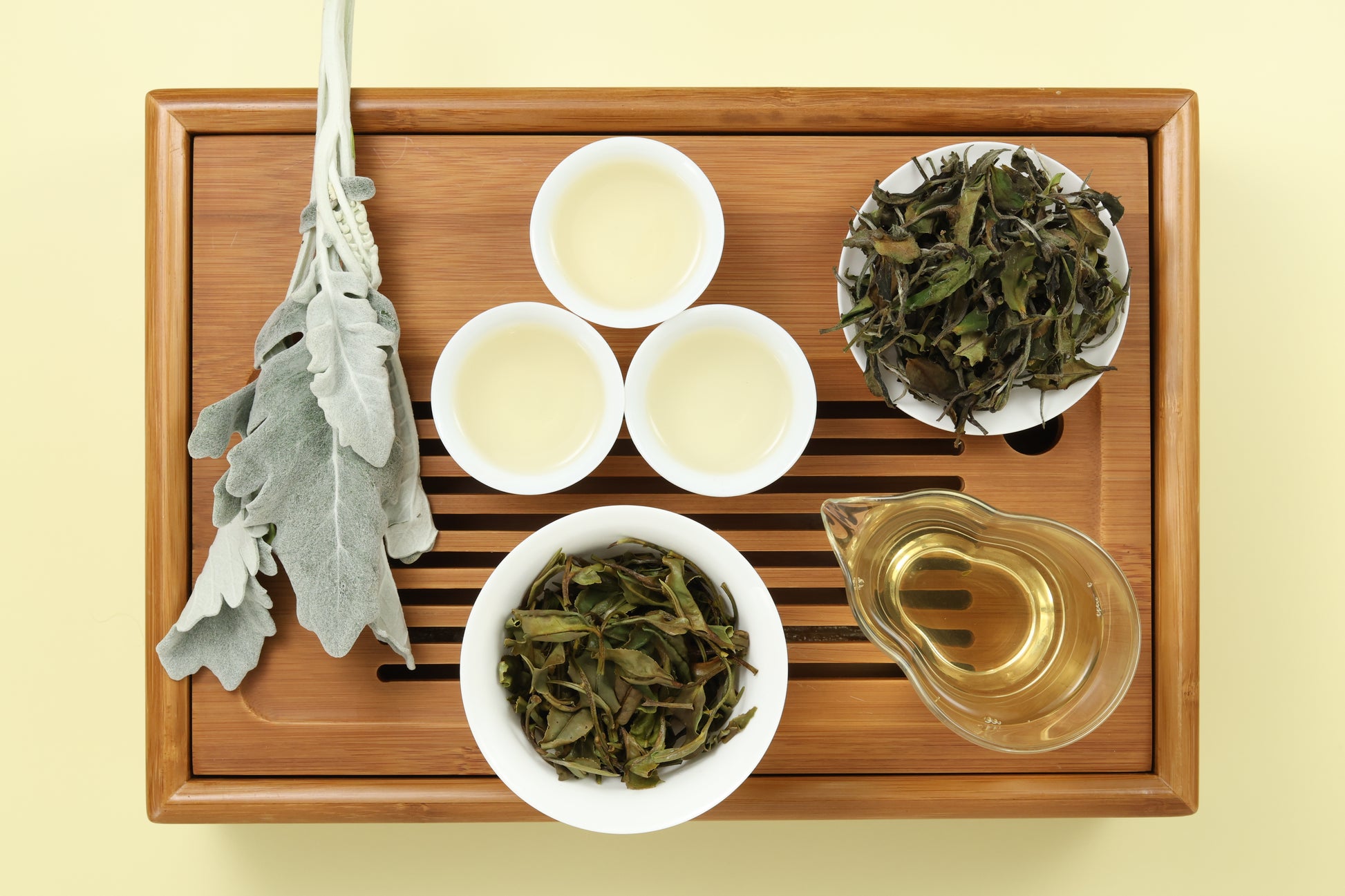 Detailed photo of Jade White Tea on a Bamboo Tea Tray with Dry, Wet and Brewed Jade White Tea from Taiwan featured prominently.