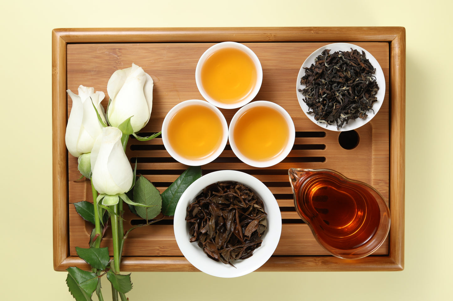 Detailed photo of Oriental Beauty Oolong on a Bamboo Tea Tray with Dry, Wet and Brewed Oriental Beauty Oolong from Taiwan featured prominently.