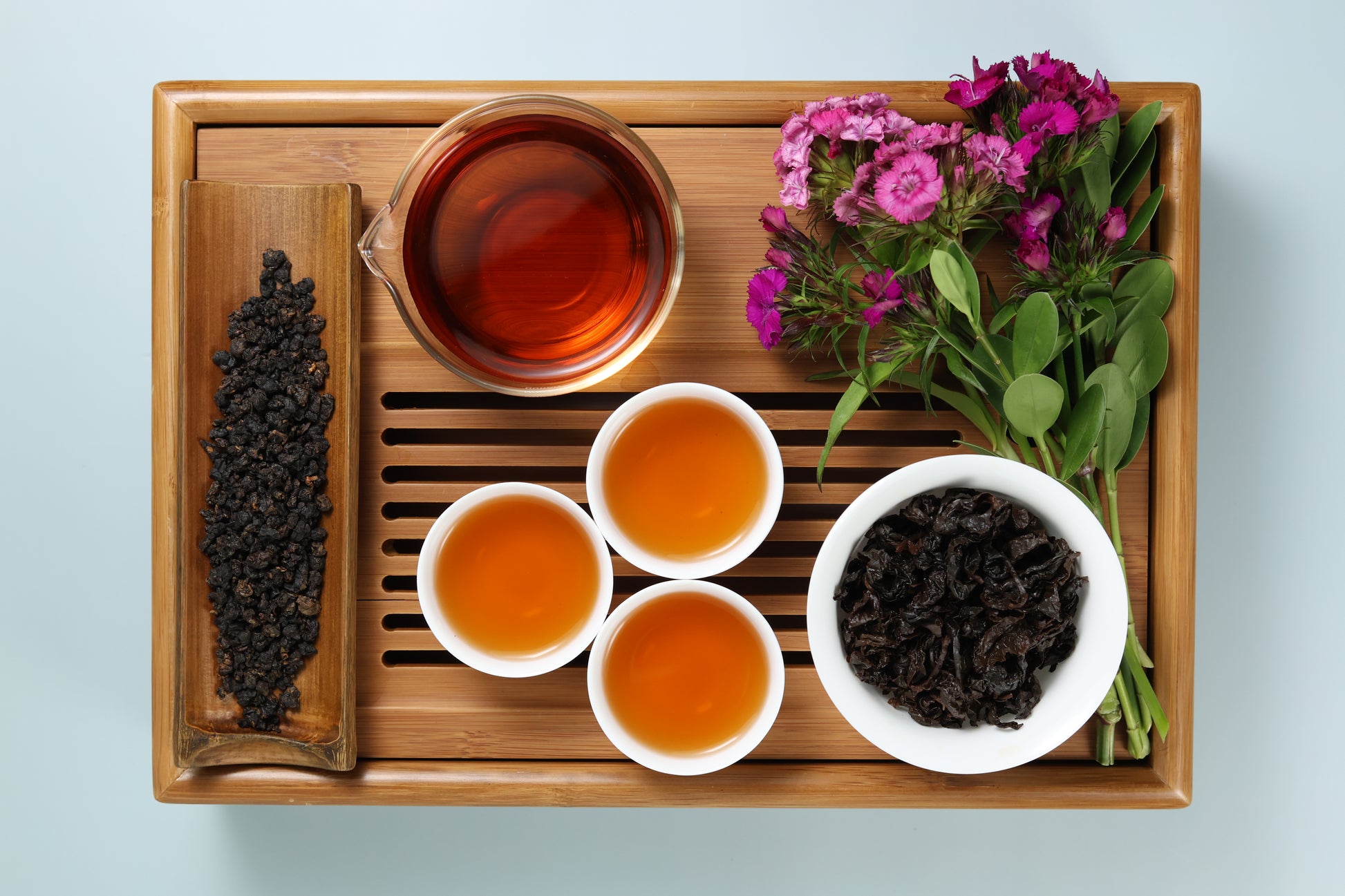 Detailed photo of Red Oolong on a Bamboo Tea Tray with Dry, Wet and Brewed Red Oolong from Taiwan featured prominently.