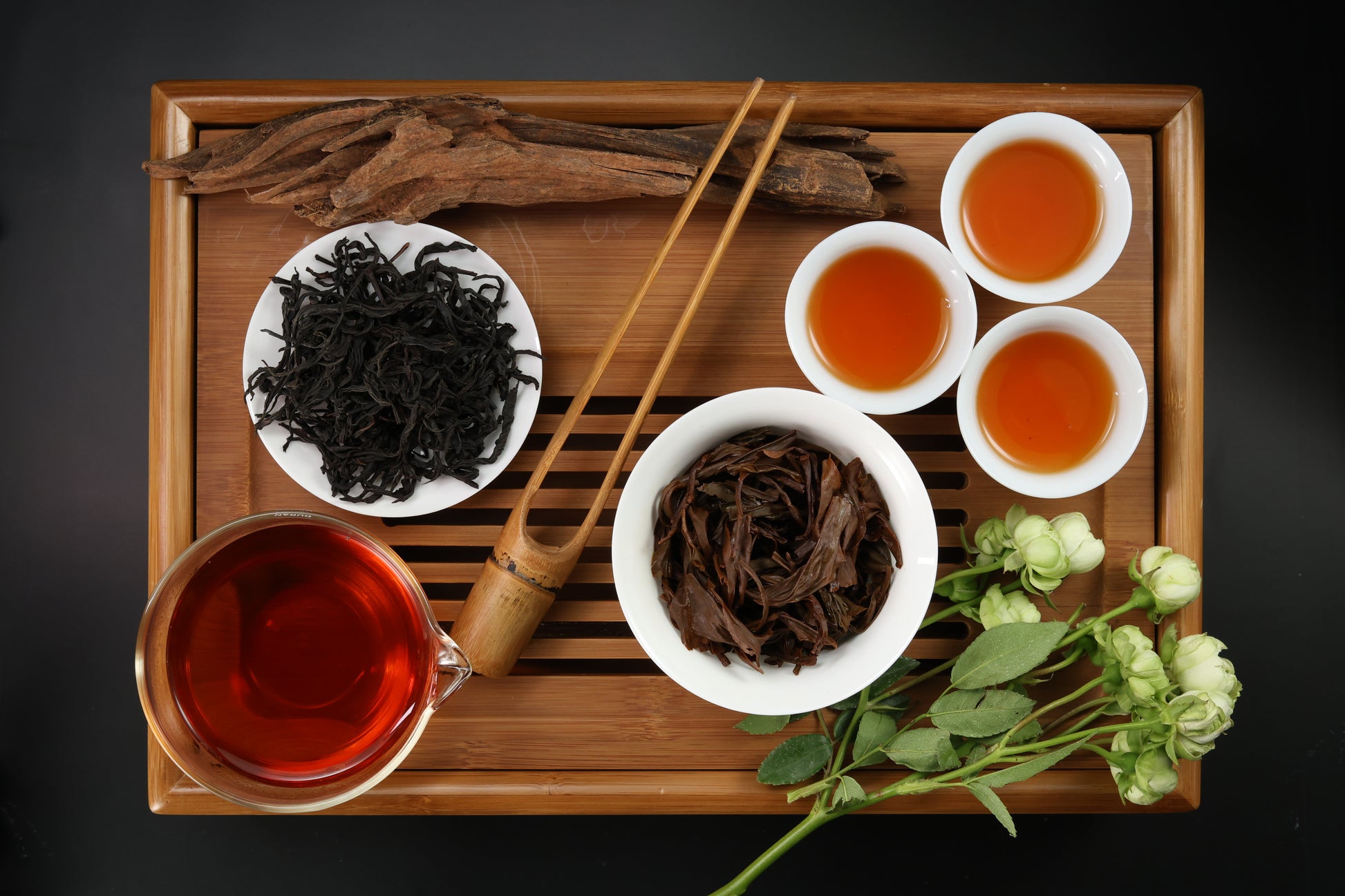 Detailed photo of Ruby 18 Black Tea on a Bamboo Tea Tray with Dry, Wet and Brewed Ruby 18 Black Tea from Taiwan featured prominently.