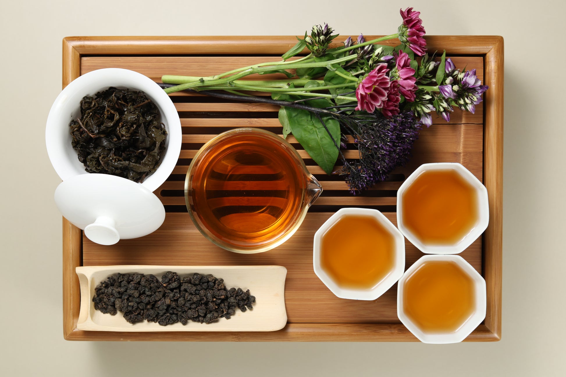 Detailed photo of Shan Lin Xi Medium Roasted Oolong on a Bamboo Tea Tray with Dry, Wet and Brewed Shan Lin Xi Medium Roasted Oolong from Taiwan featured prominently.