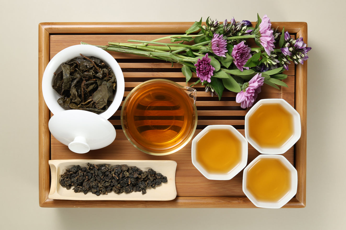 Detailed photo of Tieguanyin Medium Roast Oolong on a Bamboo Tea Tray with Dry, Wet and Brewed Tieguanyin Medium Roast Oolong from Taiwan featured prominently.