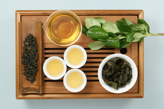 Detailed photo of Wuyi Oolong  on a Bamboo Tea Tray with Dry, Wet and Brewed Wuyi Oolong  from Taiwan featured prominently.